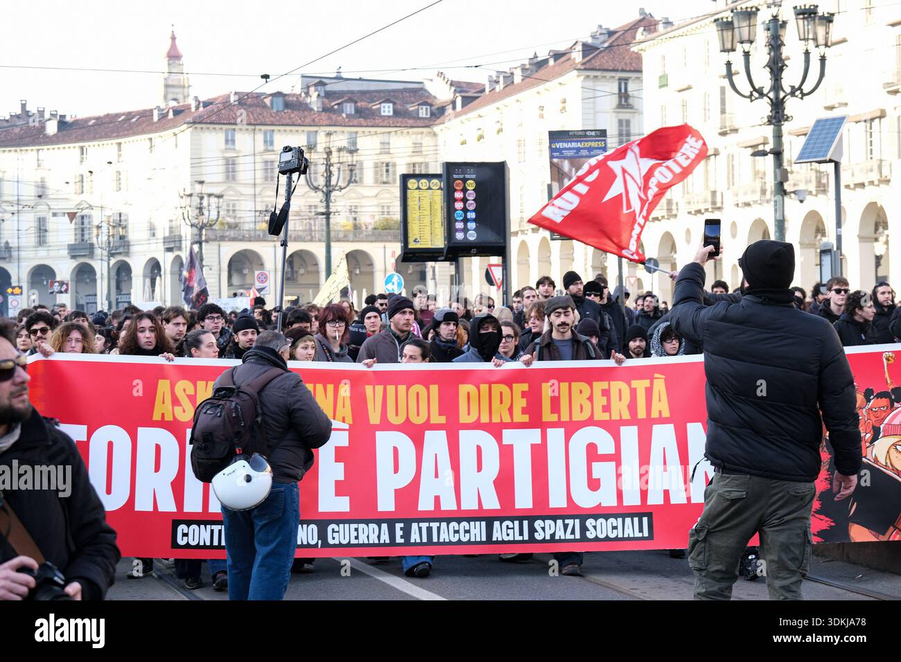 Protesters march with a banner in a national demonstration involving ...