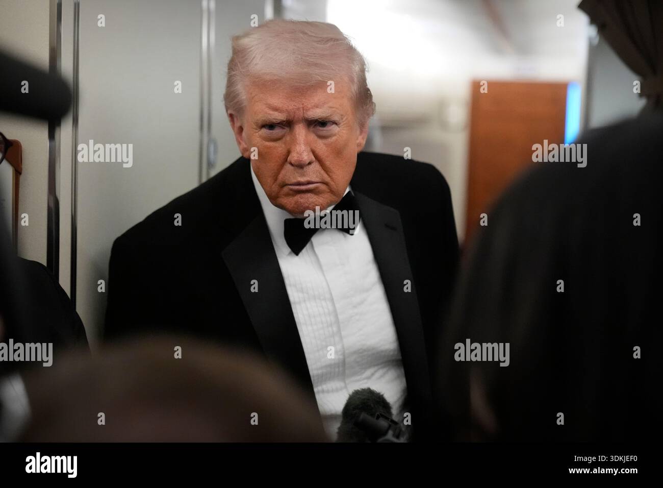 President Donald Trump speaks with reporters aboard Air Force One as he ...