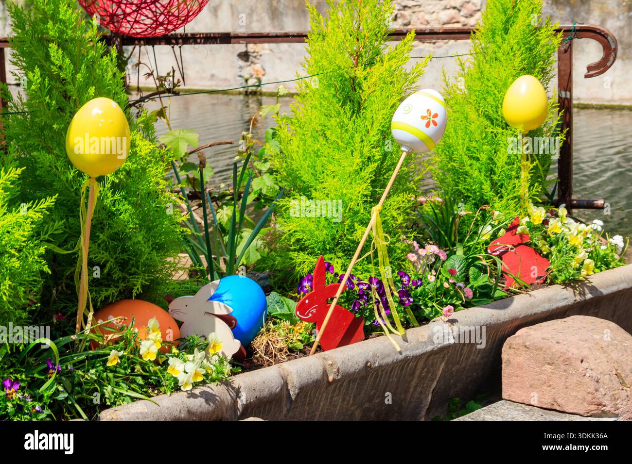 Flowerbed with flowers and Easter decoration at spring Stock Photo