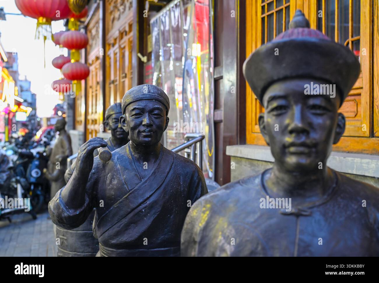 BEIJING - NOV 24: Bronze sculptures at the Qianmen Street in Beijing on November 24. 2025, China Stock Photo