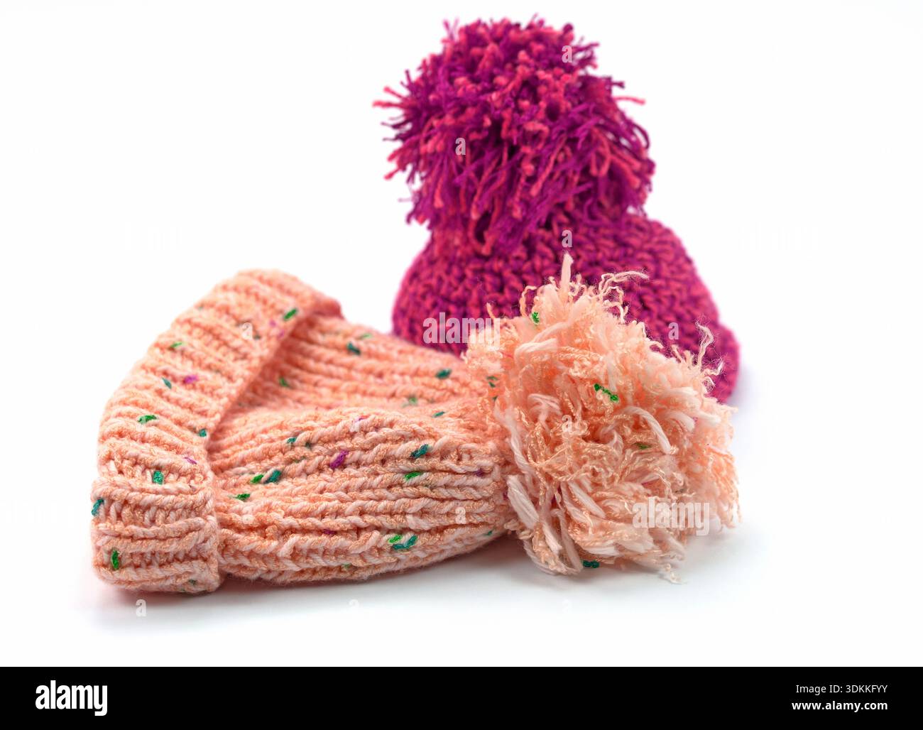 Two bobble hats against a white background Stock Photo