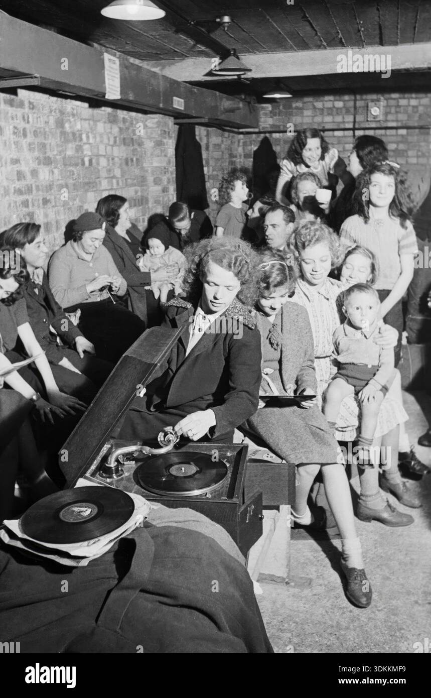 A young woman with a gramophone in an air raid shelter in north London. 1940. Stock Photo