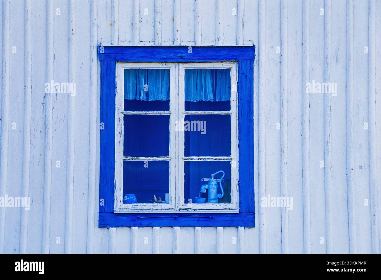 Blue window on white wooden cottage Stock Photo