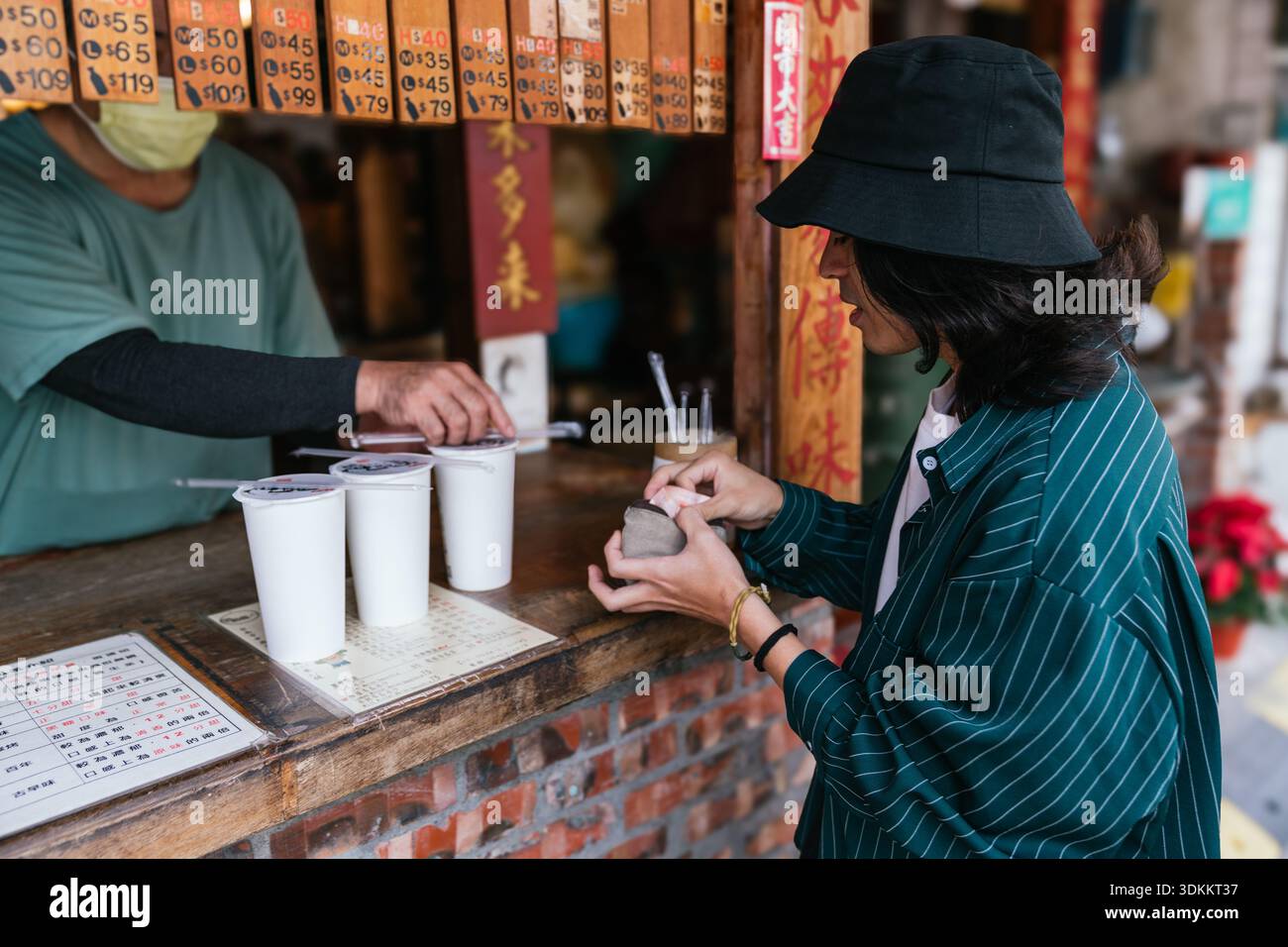Customer paying for bubble tea at street stall Stock Photo - Alamy