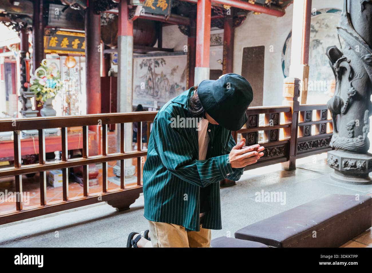 Person kneeling praying at a traditional asian temple Stock Photo - Alamy