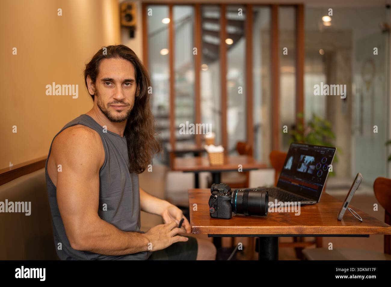 Creative freelancer man editing video content in cafe Stock Photo