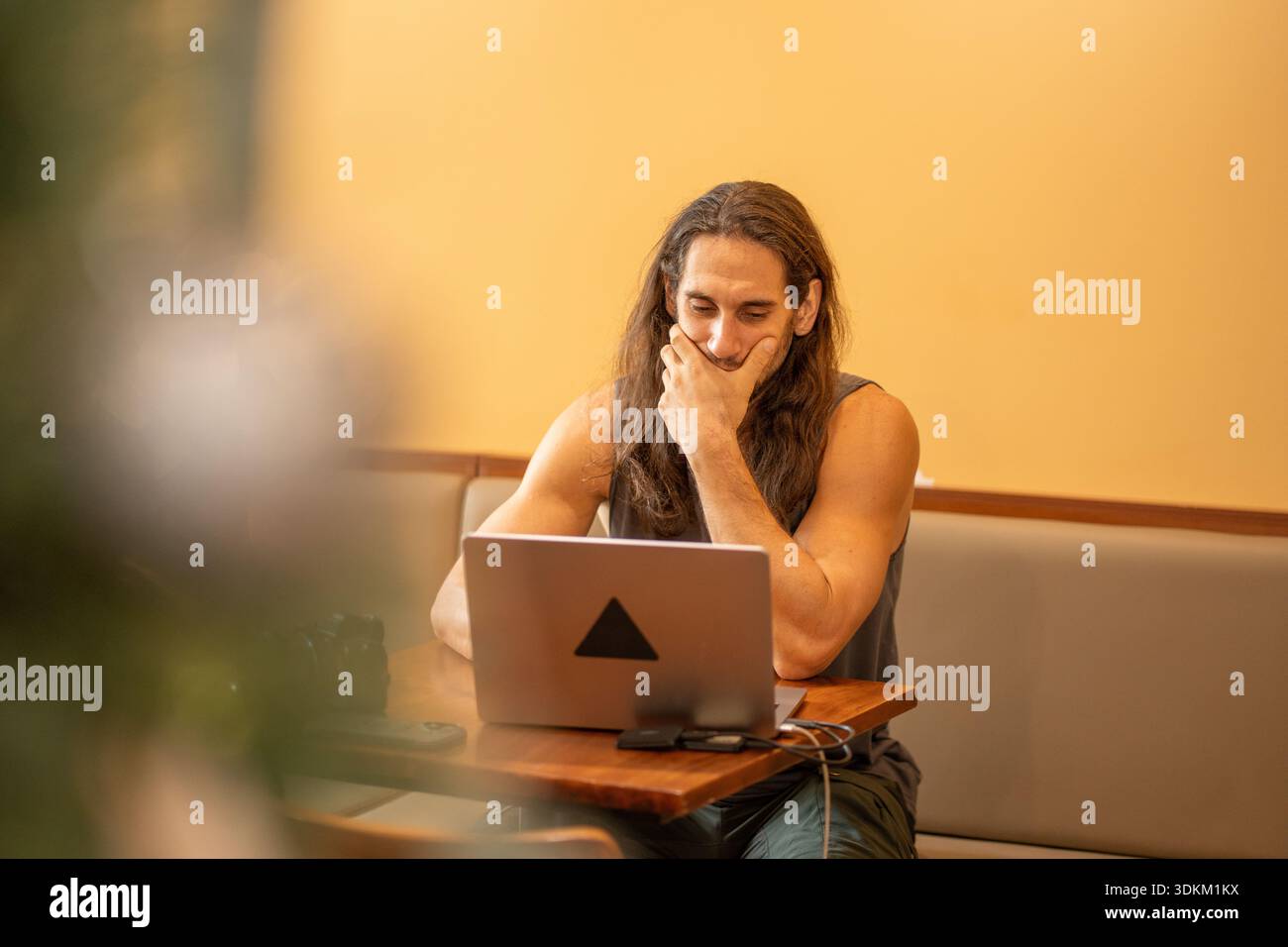Man working on laptop thinking about a problem solution Stock Photo