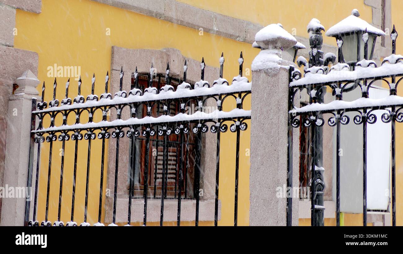 snow on the railings of the stone building Stock Photo
