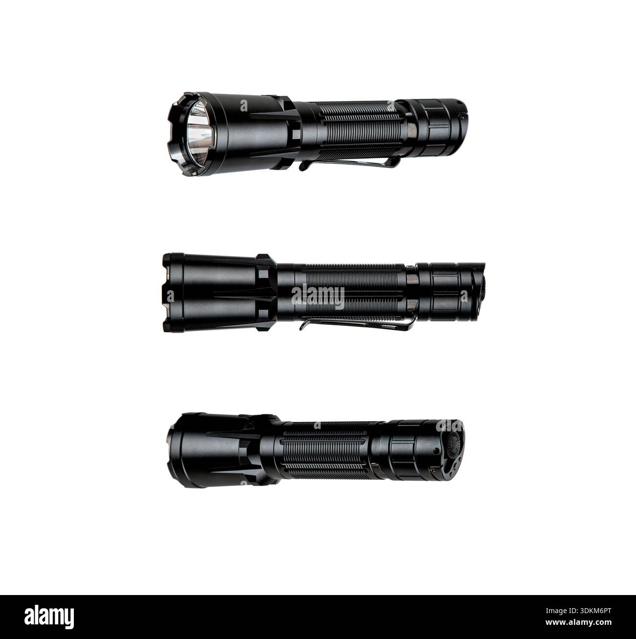 Three black tactical LED flashlights shown from different angles on a white background. Stock Photo