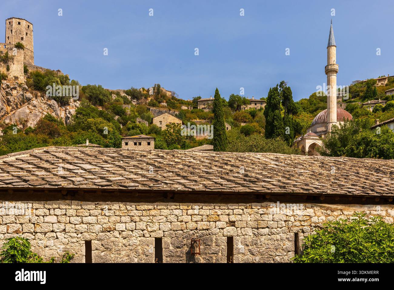 Historic stone buildings, mosque, and fort tower overlooking Capljina ...