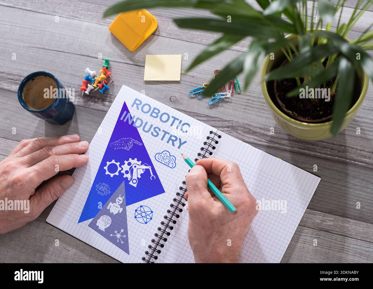 Robotic industry concept drawn on a notepad placed on a desk Stock Photo