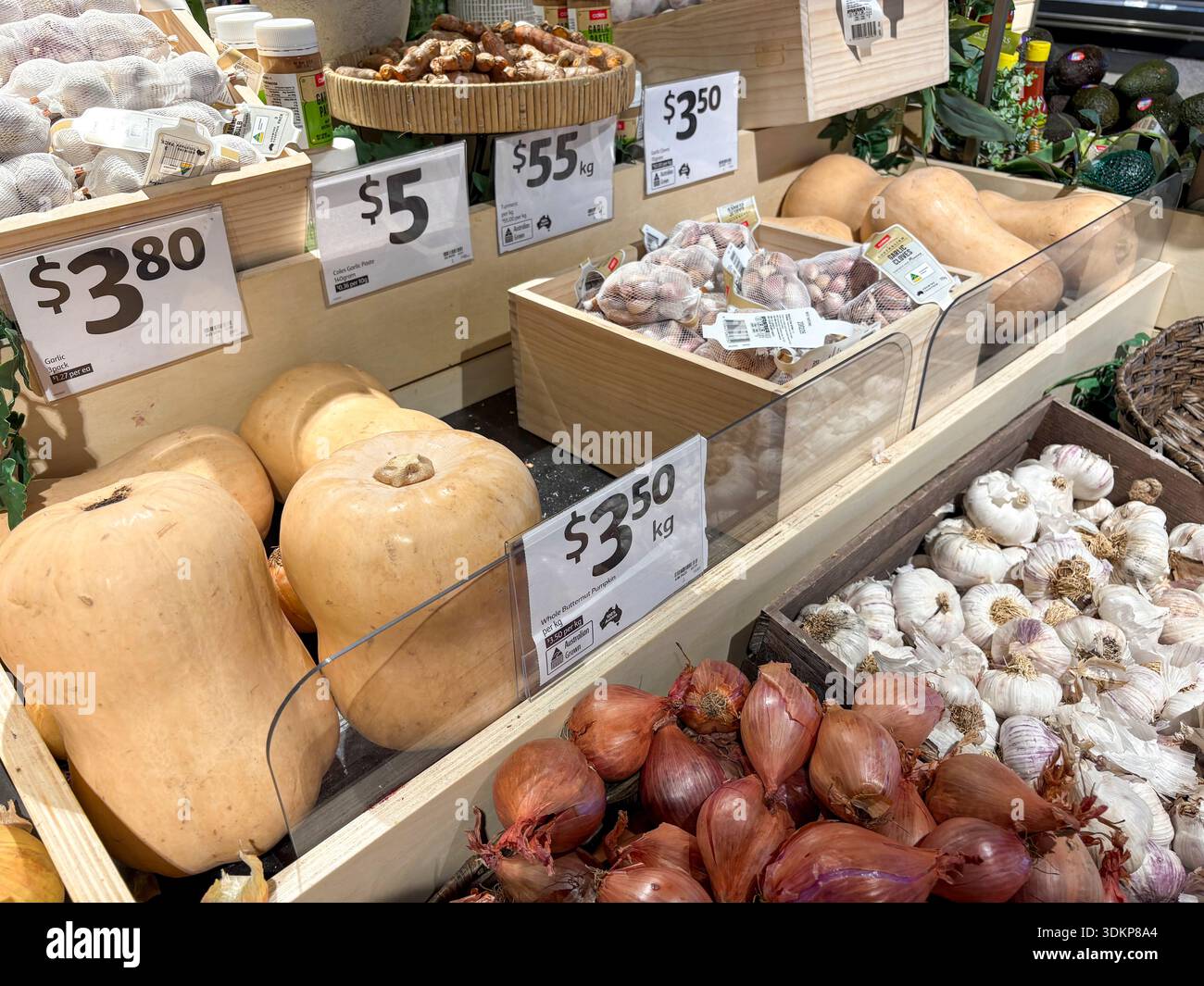 Coles supermarket in Australia, fresh vegetables section selling garlic gloves,shallots, butternut pumpkin and brown onions,Australia - Smartphone Captured Stock Image