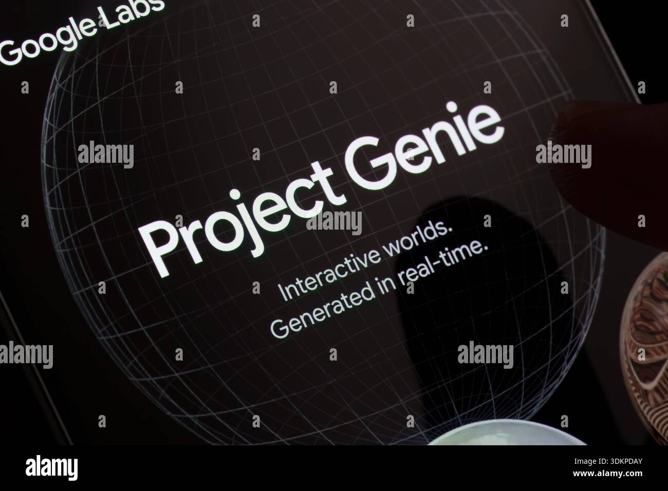 Project Genie by Google Labs displayed on smartphone screen with wireframe globe background and interactive worlds generated in real time close-up. St Stock Photo
