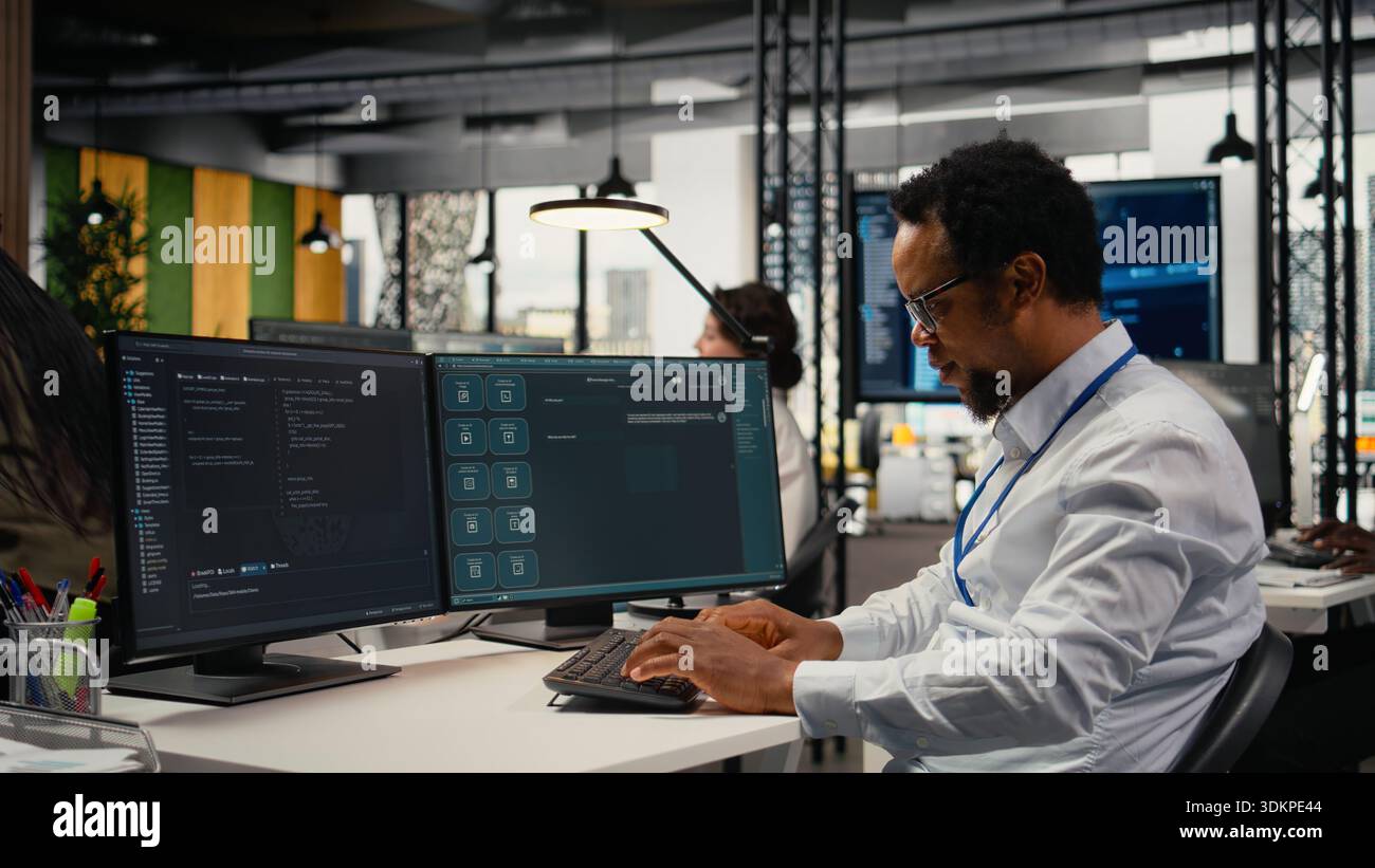 Programmer in office using AI LLM chatbot to get help optimizing systems performance metrics. IT worker in tech agency utilizing generative AI LLM assistant for faster software development, camera A Stock Photo