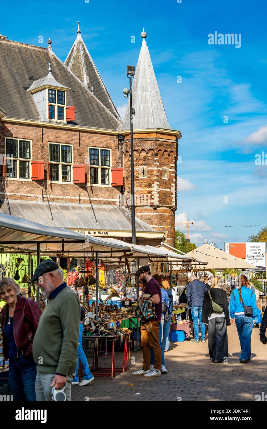 People browsing and shopping at the Waag (Dutch for "weigh house") in the Nieuwmarkt square in Amsterdam, Netherlands Stock Photo