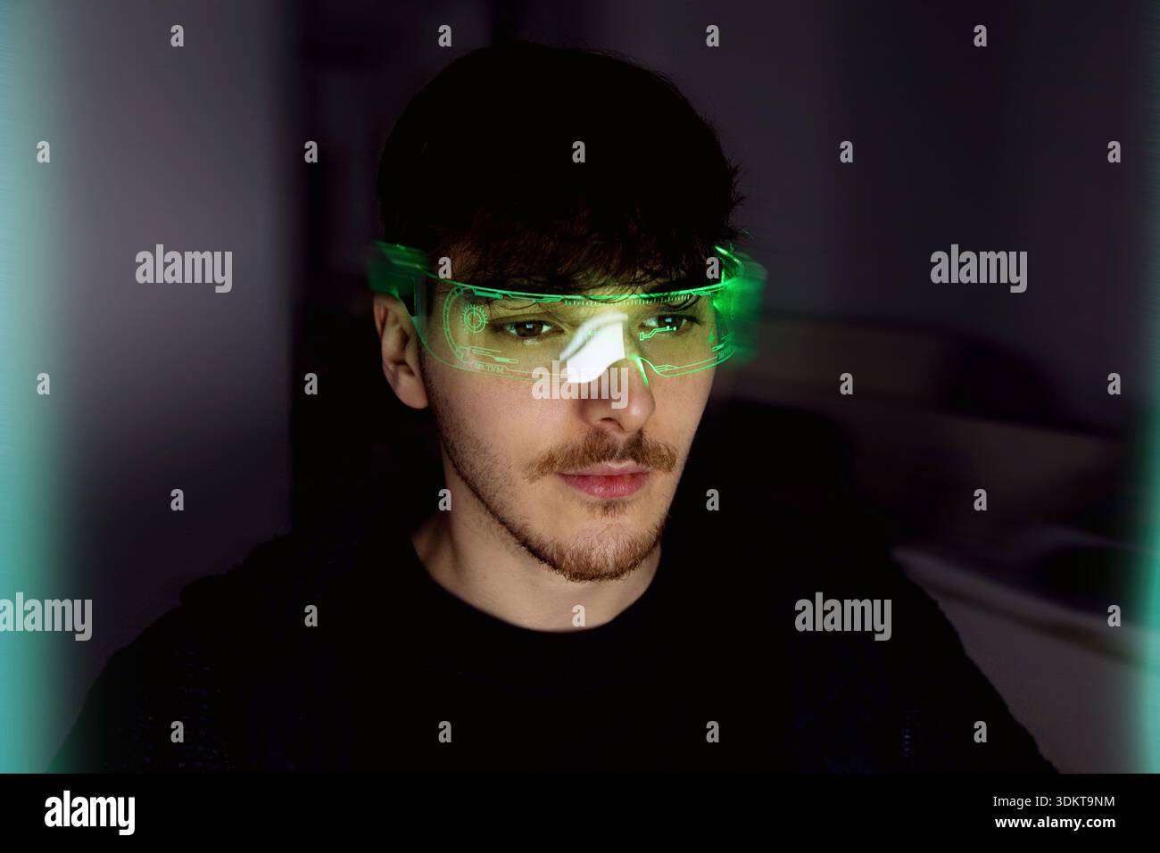 Young man using computer with led cyber glasses Stock Photo
