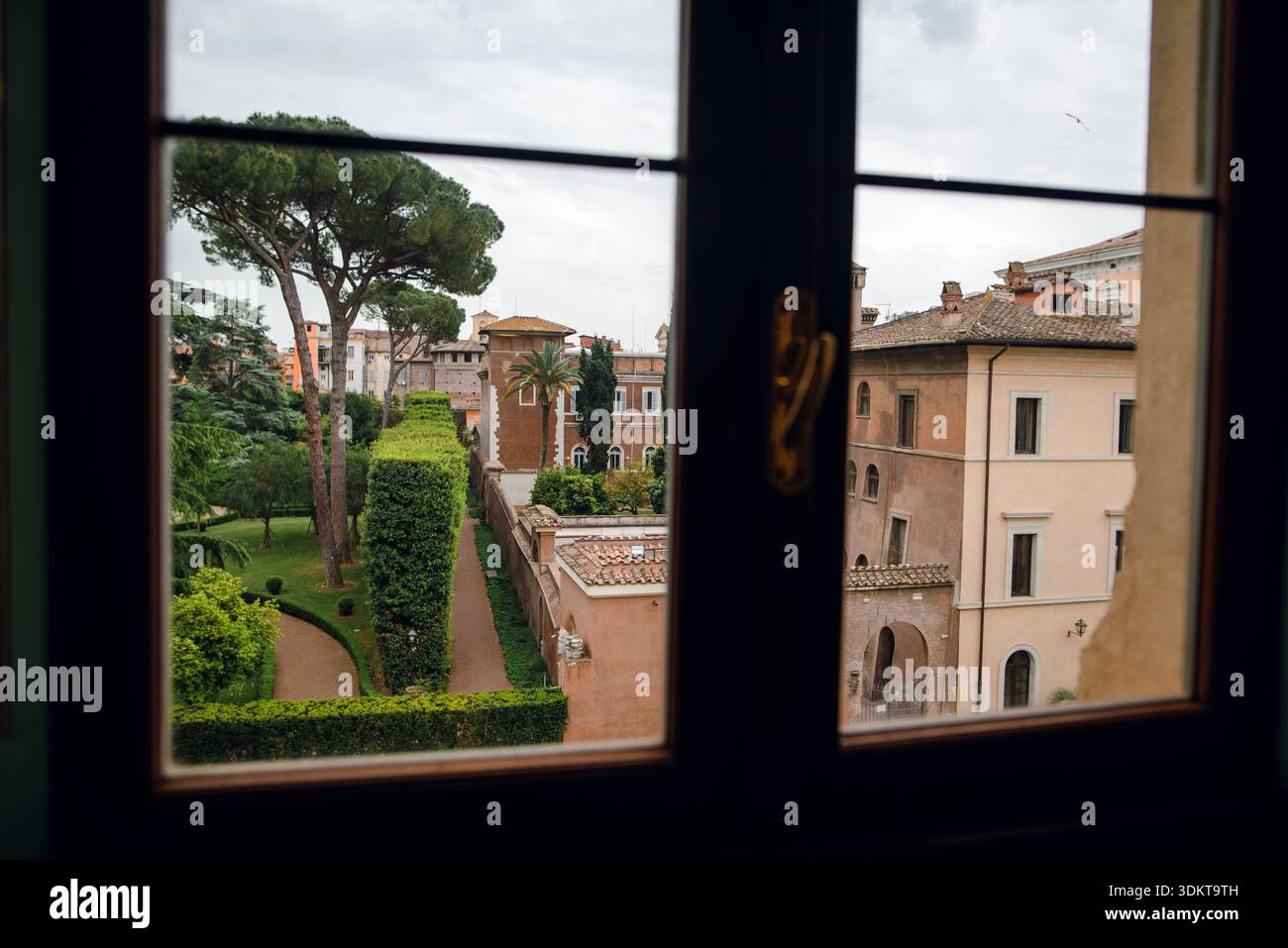 View of Roman Garden Through Window Stock Photo