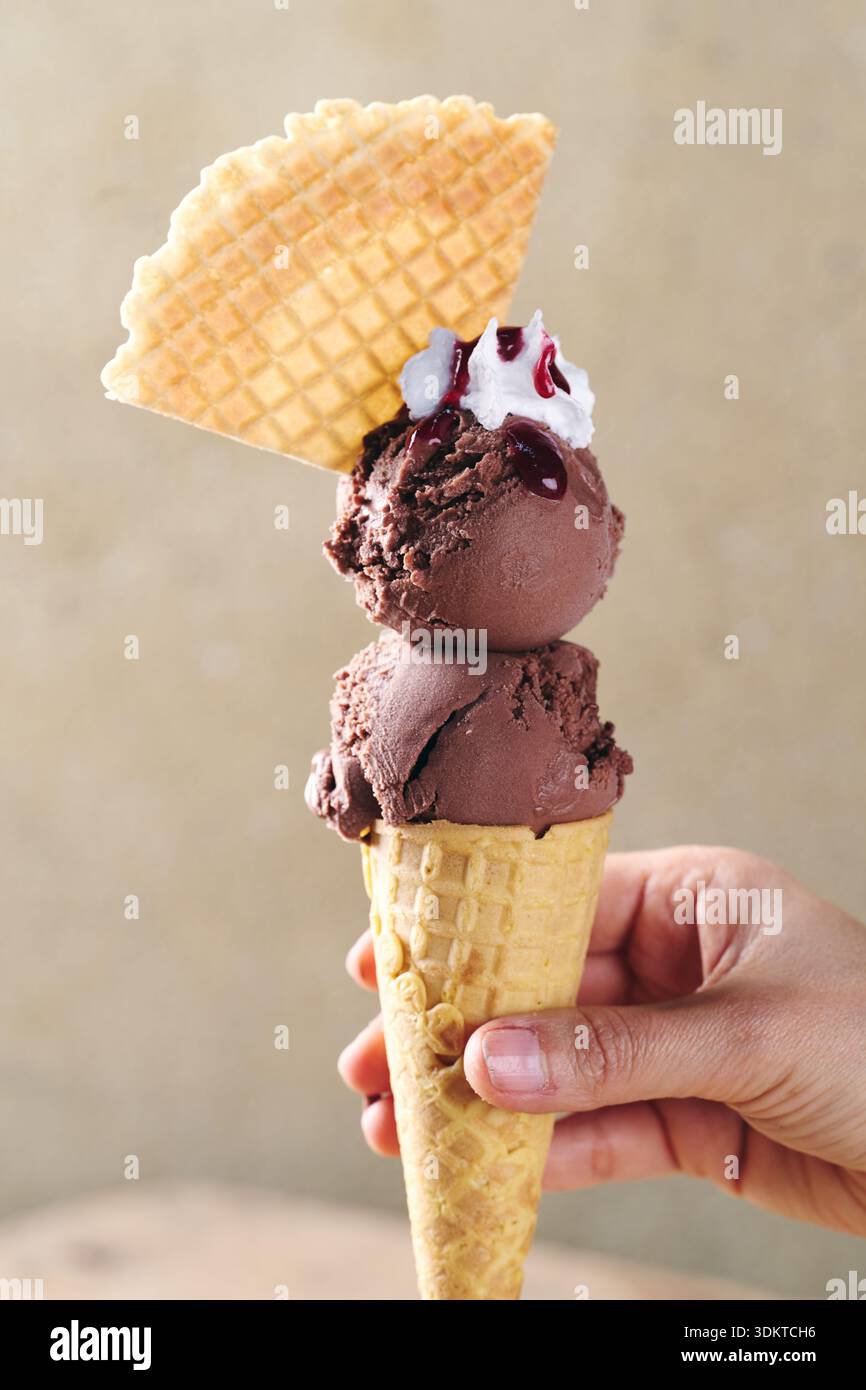 chocolate ice Cream in hand Stock Photo