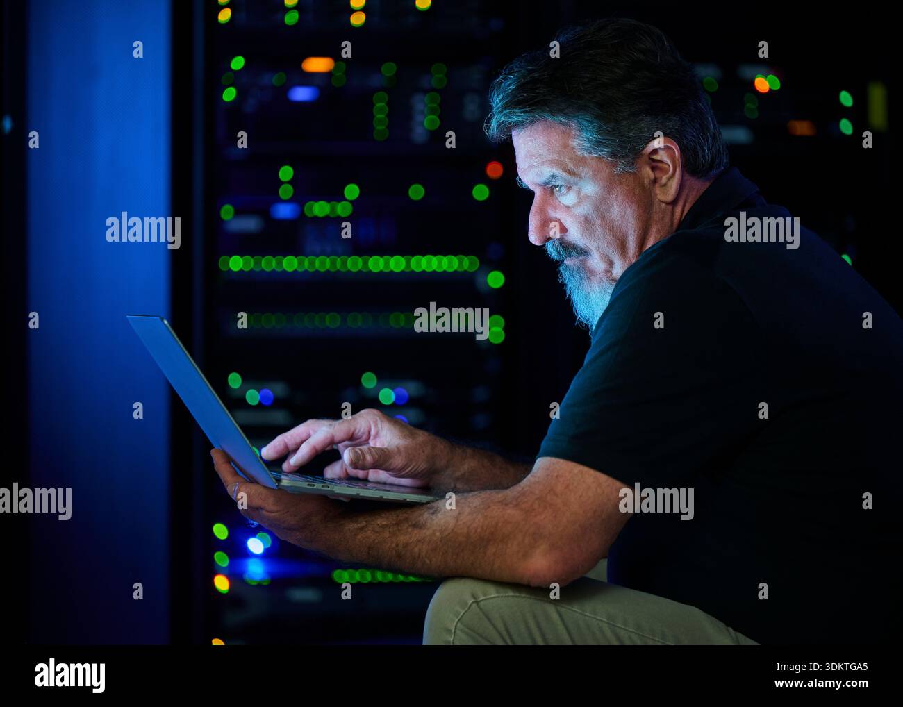 Man using laptop in data center Stock Photo