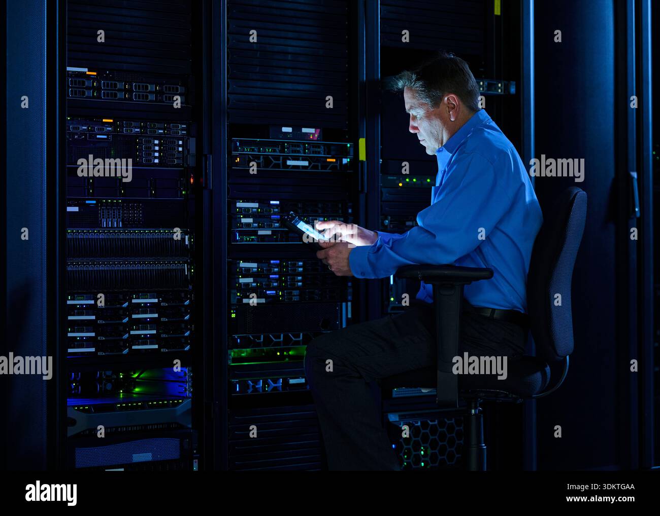 Man using digital tablet in data center Stock Photo