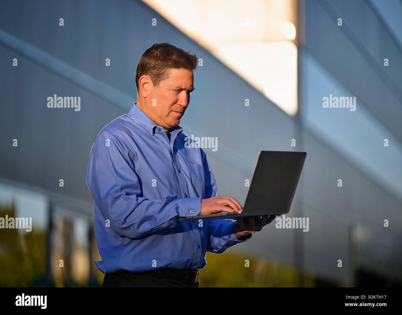 Man working on laptop outdoors Stock Photo