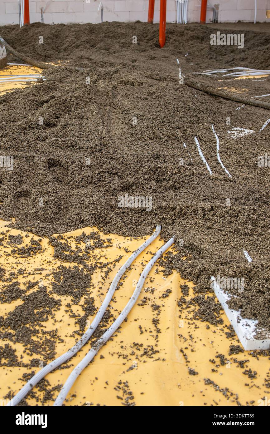 Indoor construction site floor in progress with yellow vapor barrier ...