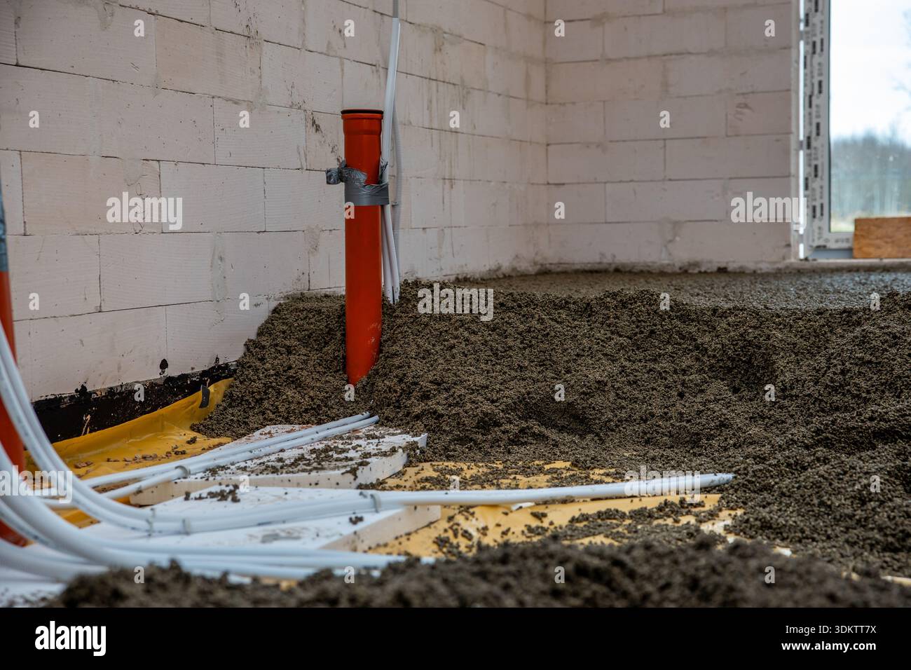 Interior of a construction site with white concrete block walls, an ...