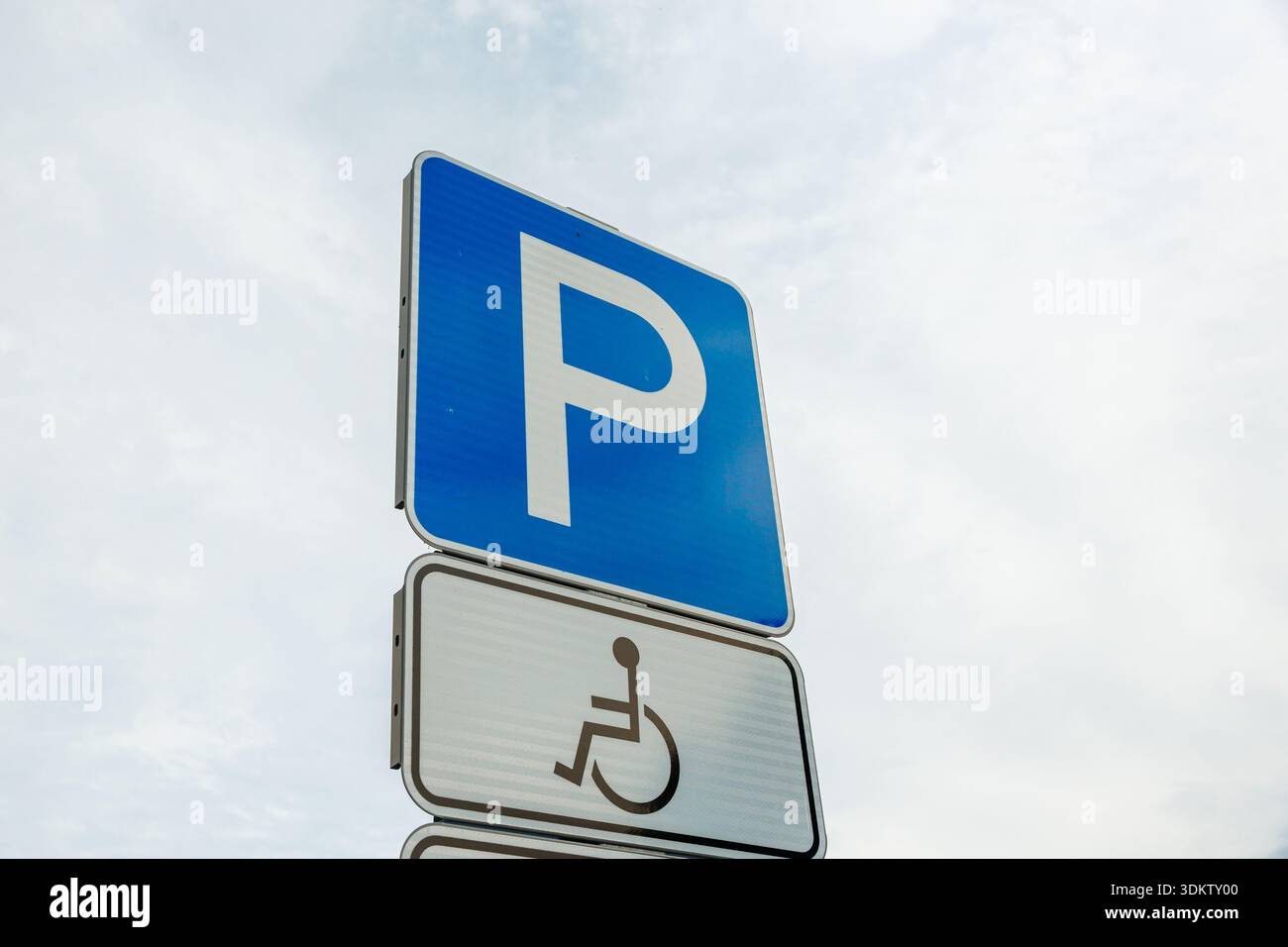 A blue parking sign with a white P and a wheelchair symbol below, set ...