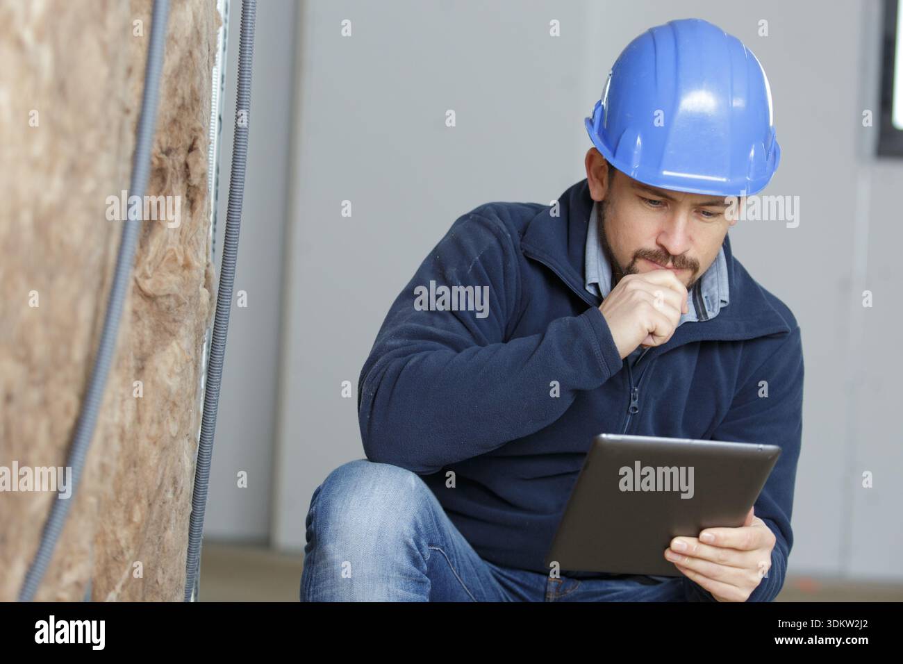 a builder working on computer tablet Stock Photo