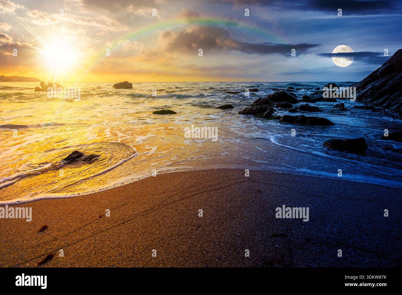 empty sandy beach at the sea. day and night time change concept. white foam rolling on to the shore near boulder with sun and moon at twilight. perfec Stock Photo