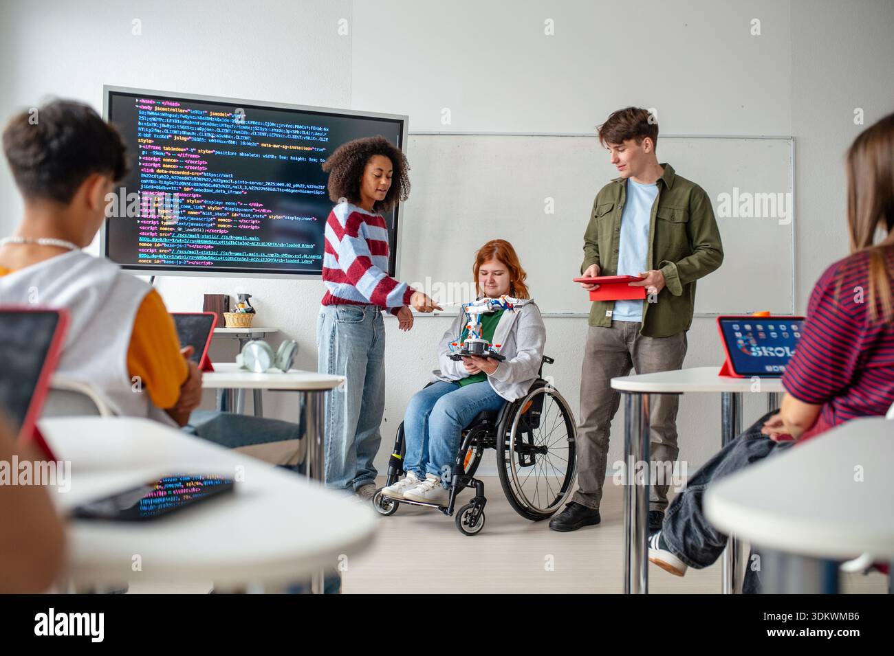 Inclusive student team presenting technology project in class. Stock Photo