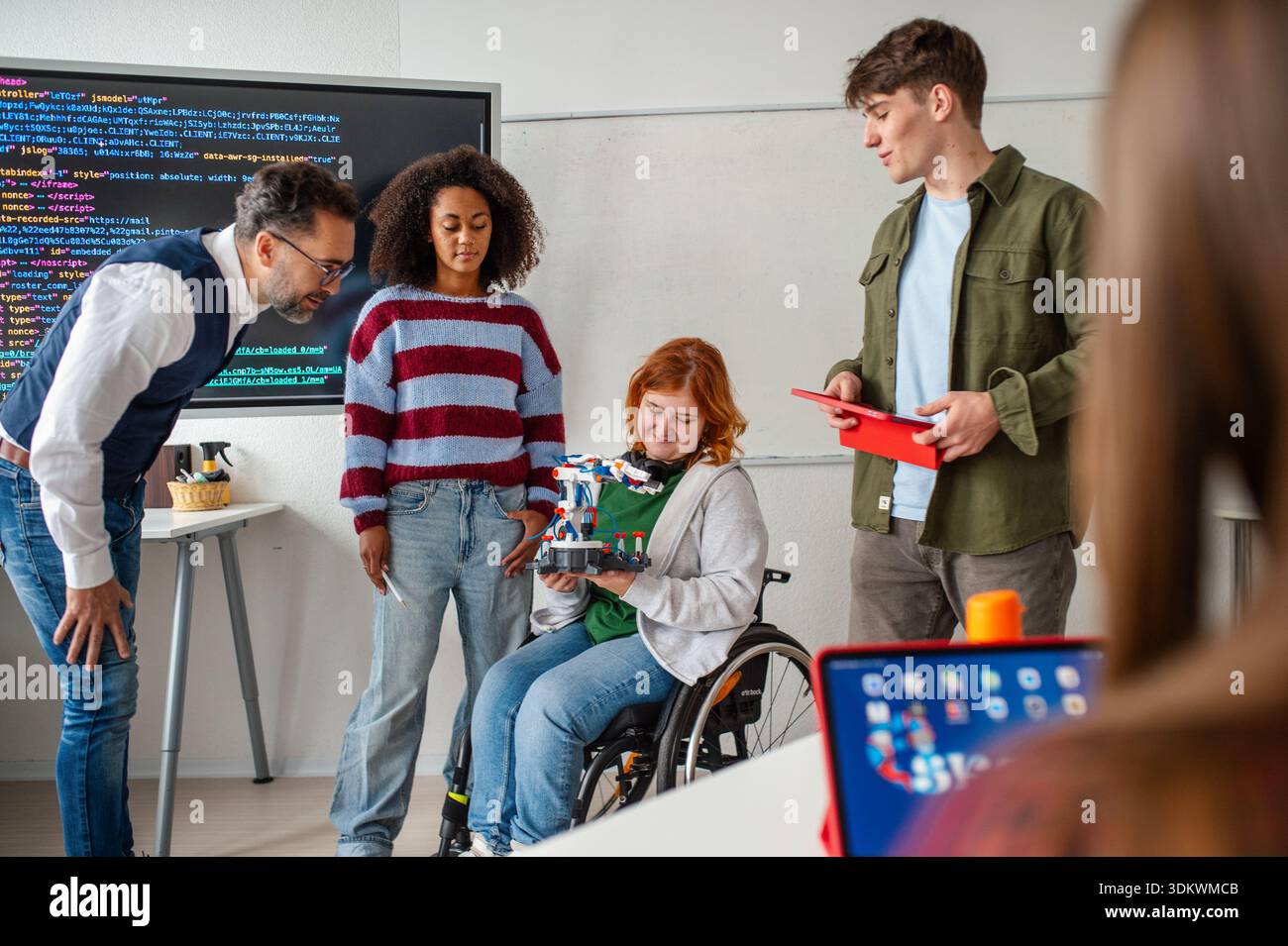 Inclusive student team presenting technology project in class. Stock Photo