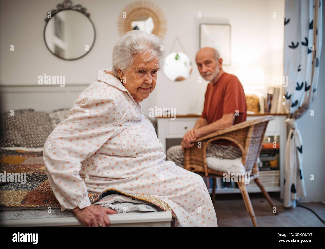 Elderly spouses sharing quiet moment before sleep. Stock Photo