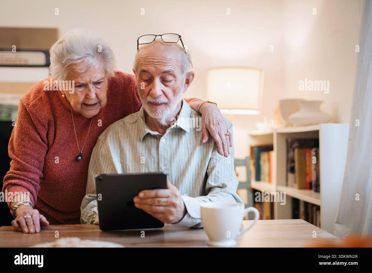 Senior coule working with tablet, having problem with technology. Stock Photo