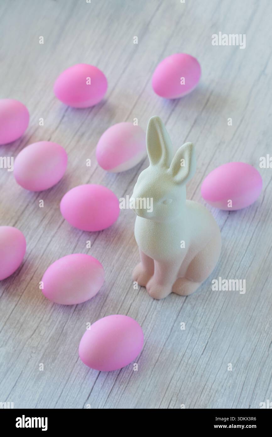Ceramic Easter bunny and eggs dyed pink Stock Photo