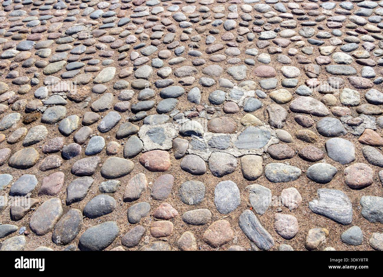 Old cobblestone pavement as creative background texture Stock Photo