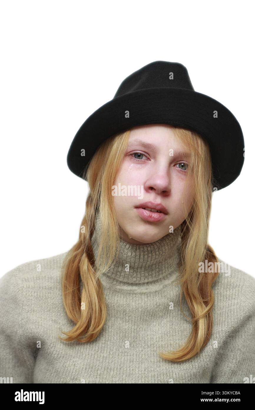 Upset girl in a black hat Stock Photo - Alamy