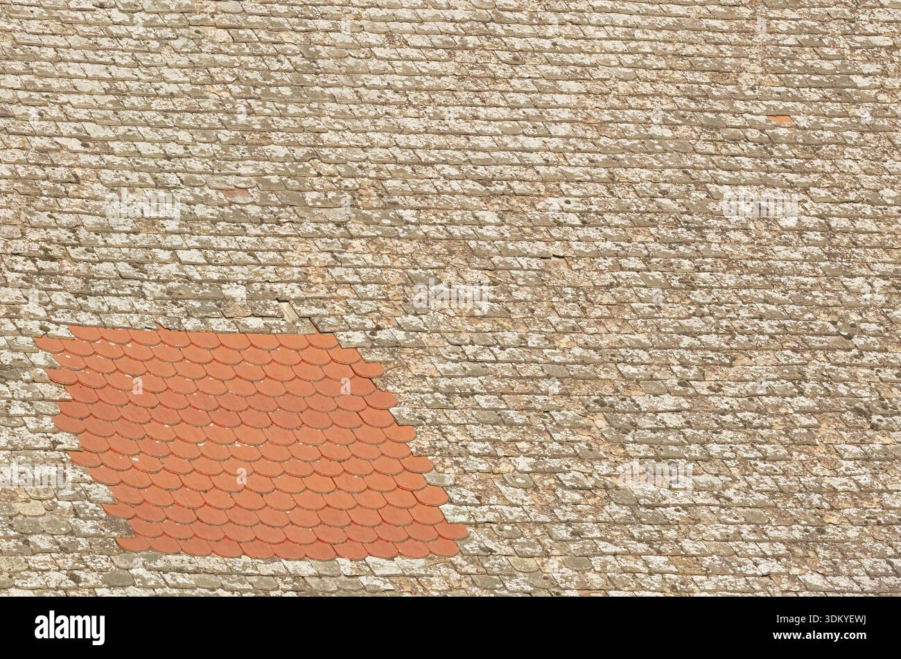 Red Tile Repaired Weathered Textured Rooftop Closeup Stock Photo