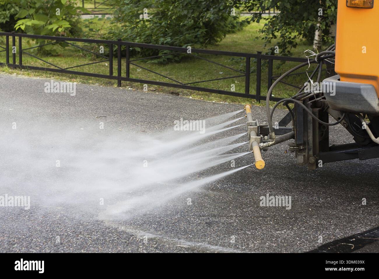 Watering machine in the street Stock Photo
