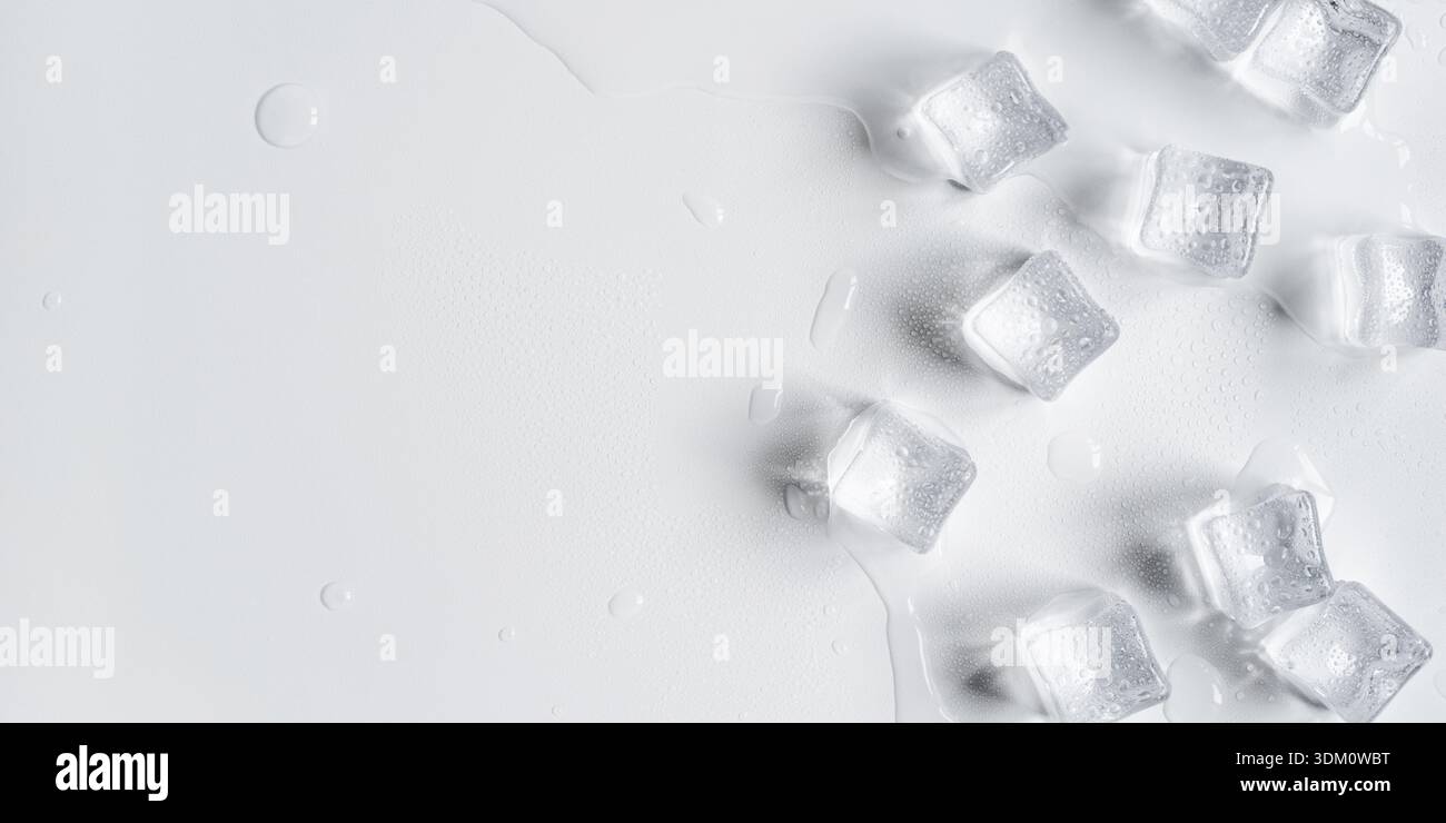 Melting ice cubes in a splash of water on a white background Stock Photo
