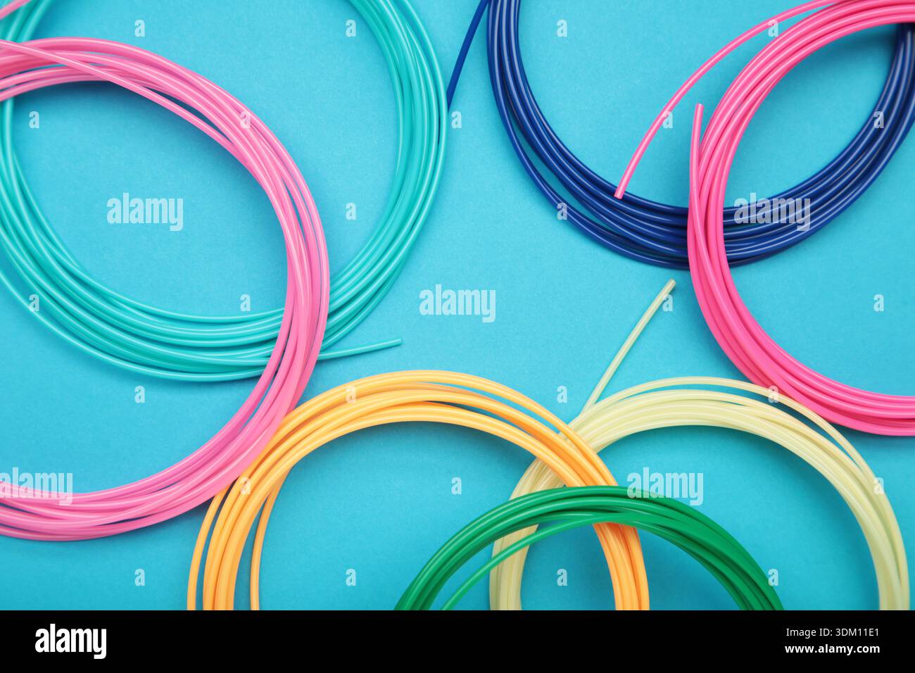 3d pen for creating volume plastic figures on blue background. Top view Stock Photo