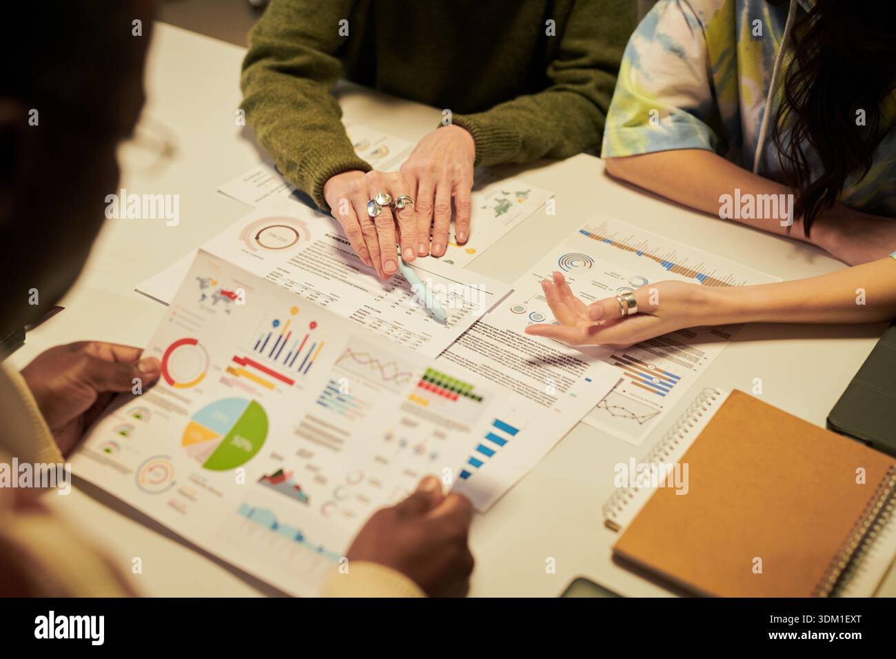 Diverse Young People Collaborating on Business Analytics at Office Table Stock Photo
