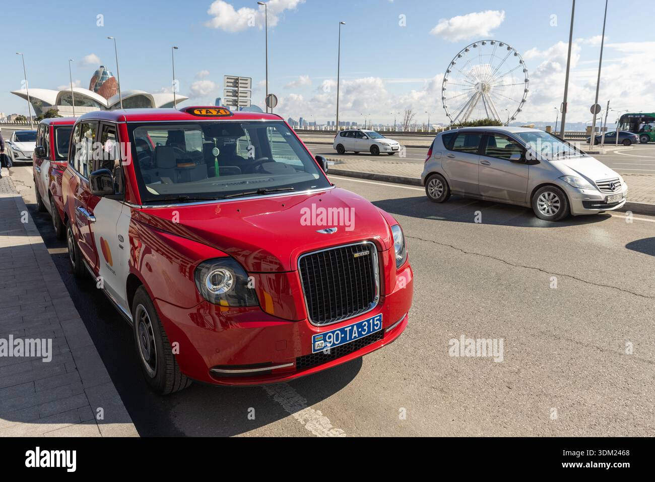 Baku, Azerbaijan - March 25, 2025: A vivid red taxi sits parked
