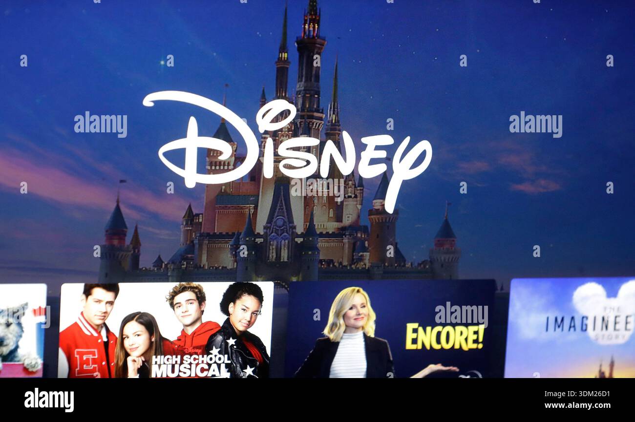 FILE - A Disney logo forms part of a menu for the Disney Plus movie and ...
