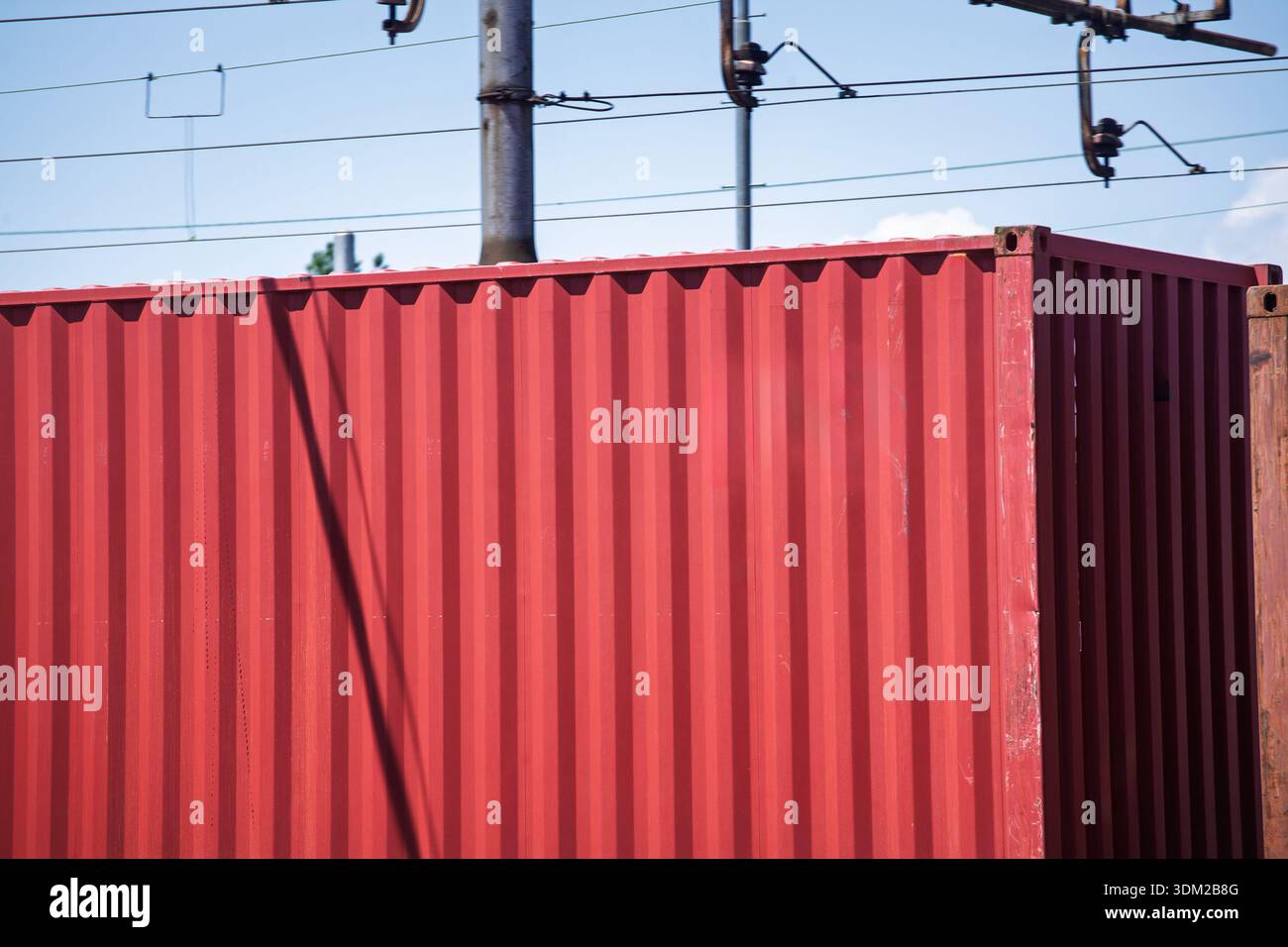 Close-up of a red corrugated shipping container on a freight train ...