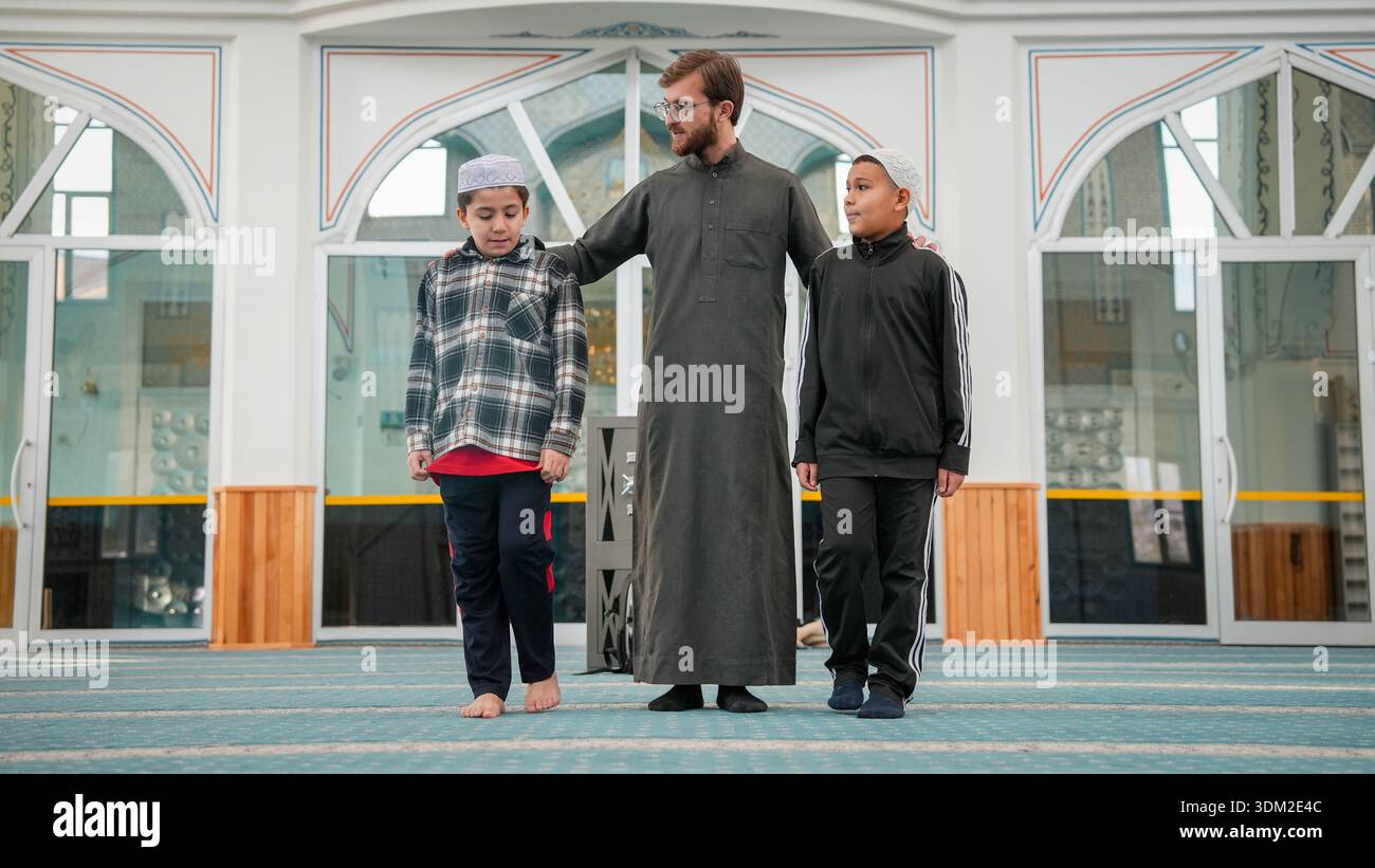 Muslim Sheikh bonding and chatting with Quran students wearing kufi ...