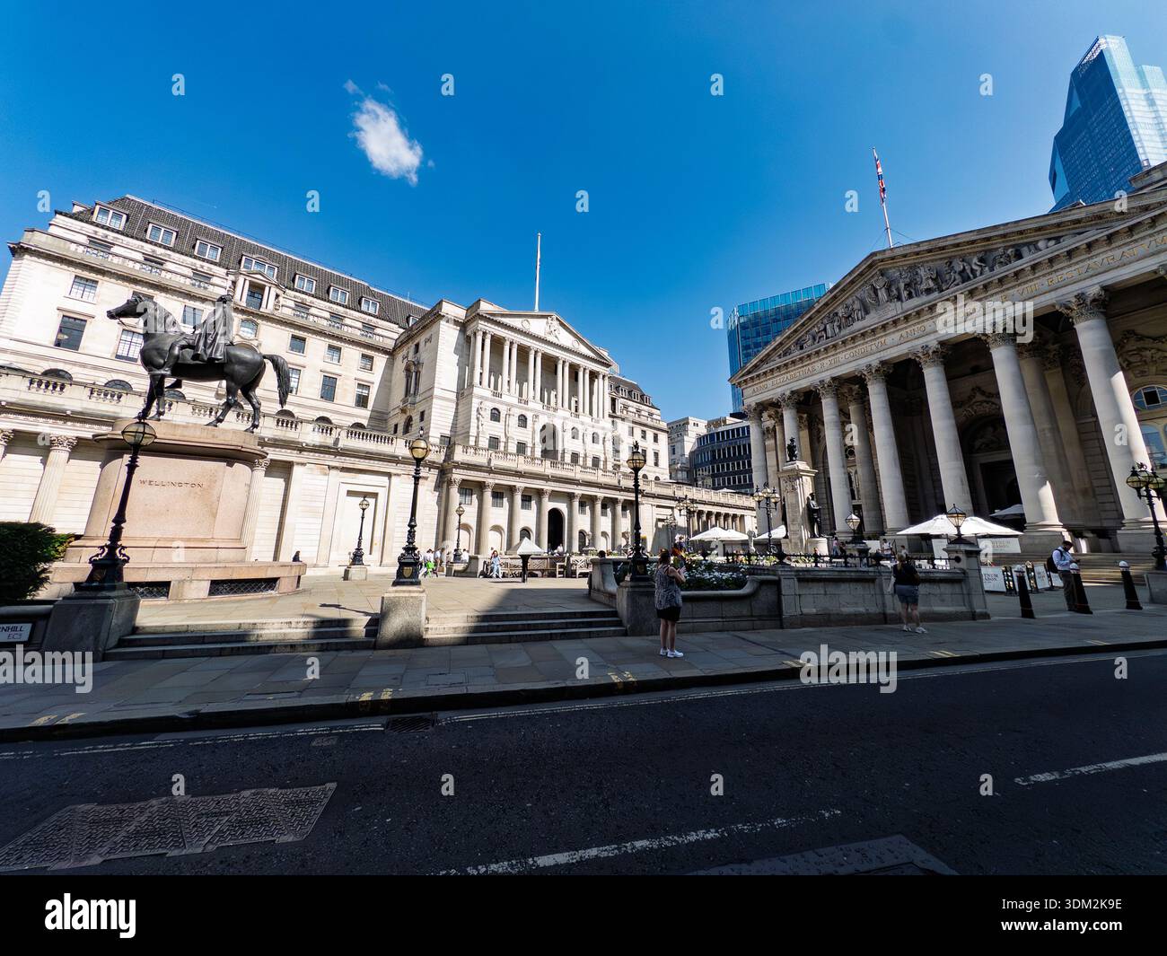 Duke of Wellington equestrian statue in front of grand Royal Exchange columns and Bank of England facade, tourists in sunny City of London plaza - Smartphone Captured Stock Image
