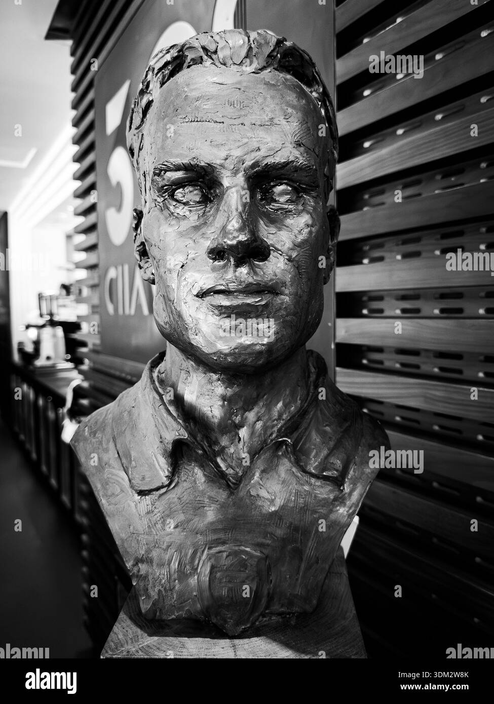 Black and white close-up bronze bust of Arsenal FC icon Dennis Bergkamp beside “50” sign in Emirates Stadium - Smartphone Captured Stock Image