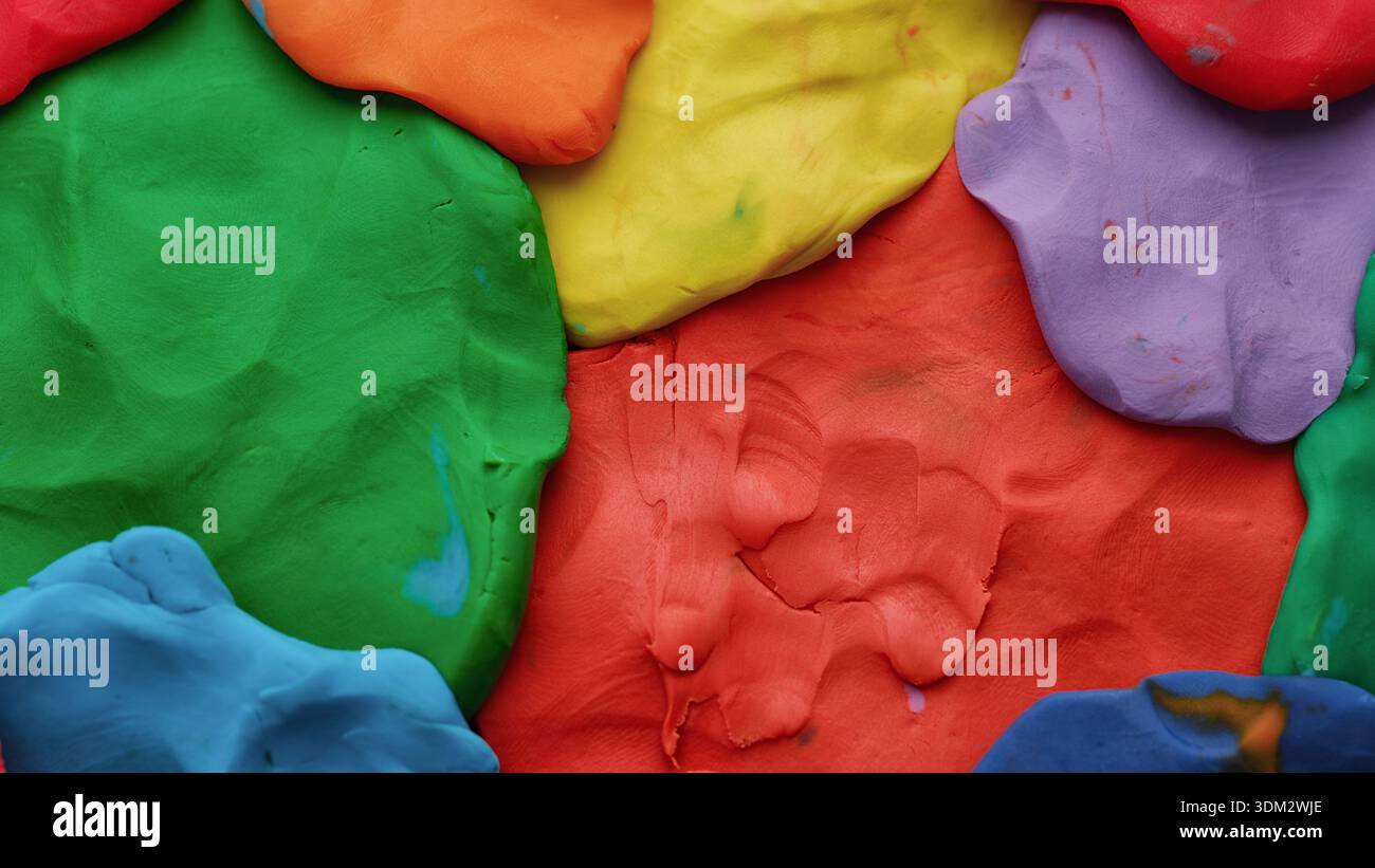 A background texture made out of multicolored play clay. Close up. Stock Photo