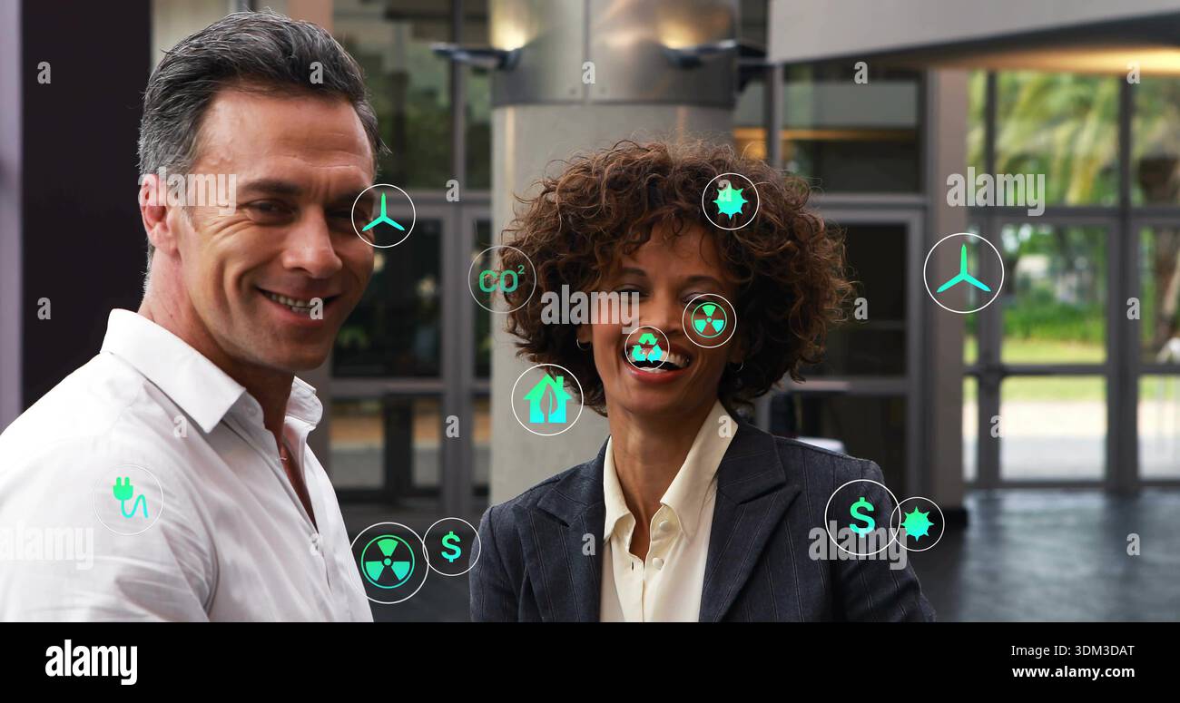 Standing two execs presenting energy visuals in atrium, with floating ...
